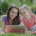 mother-with-daughter-laptop-outdoor