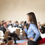21228500 – beautiful business woman is speaking on conference