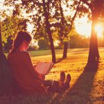 46674853 – girl reading book at park in summer sunset light