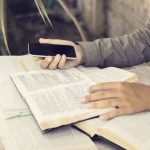 47842416 – girl with cell phone and books outdoor